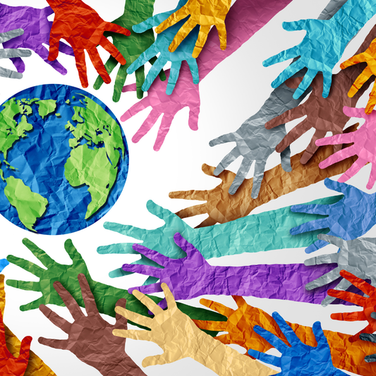 Diverse hands reaching toward a globe representing inclusion, equity, and cultural diversity in dental healthcare practices